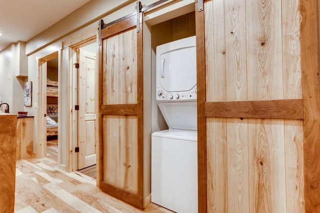 103 Victory Ln, Breckenridge, CO 80424 - laundry room featuring stacked washing maching and dryer and laundry area