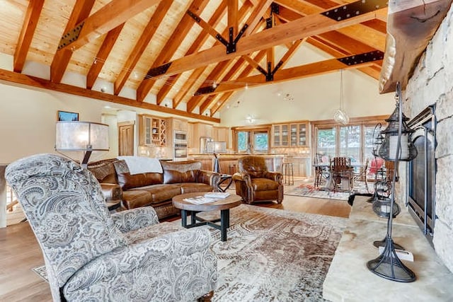 103 Victory Ln, Breckenridge, CO 80424 - living room featuring beamed ceiling, a fireplace, light wood finished floors, and high vaulted ceiling