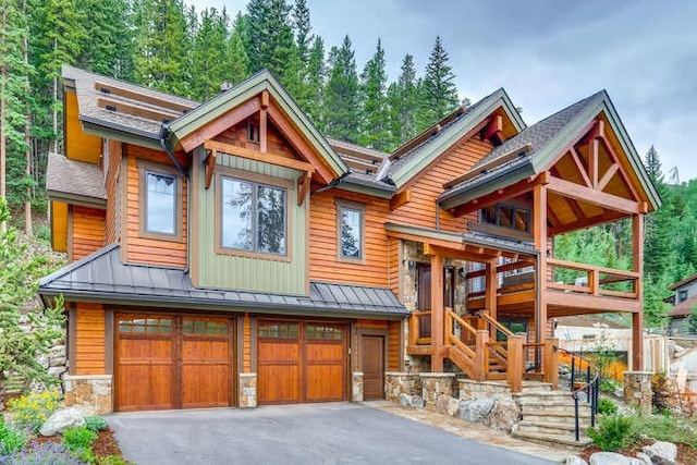 103 Victory Ln, Breckenridge, CO 80424 - view of front facade with metal roof, stone siding, a standing seam roof, and stairway
