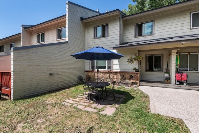 4 Sequoia Ct, Steamboat Springs, CO 80487 - back of property featuring a patio area, a yard, and stone siding
