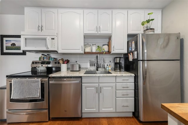 4 Sequoia Ct, Steamboat Springs, CO 80487 - kitchen featuring appliances with stainless steel finishes, white cabinetry, and light wood-type flooring