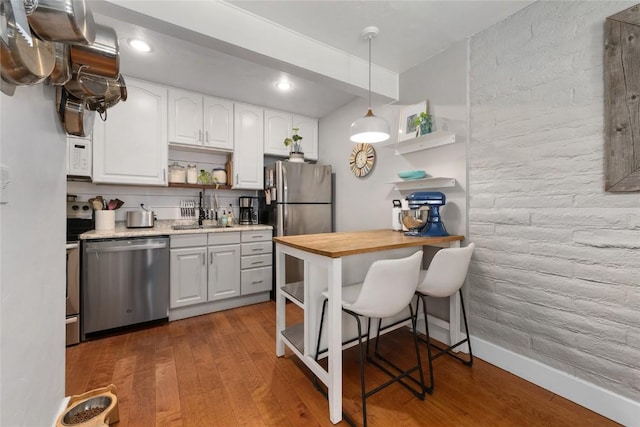 4 Sequoia Ct, Steamboat Springs, CO 80487 - kitchen with open shelves, stainless steel appliances, wood finished floors, white cabinets, and recessed lighting