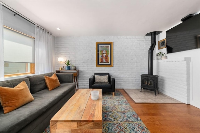 4 Sequoia Ct, Steamboat Springs, CO 80487 - living area featuring wood finished floors, a wood stove, and brick wall