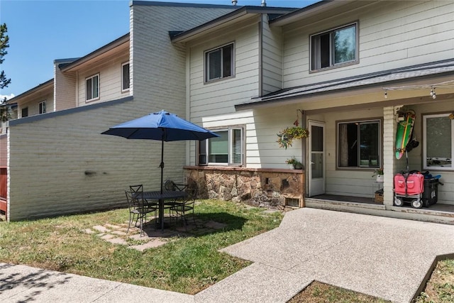 4 Sequoia Ct, Steamboat Springs, CO 80487 - rear view of property featuring a patio, stone siding, and a yard