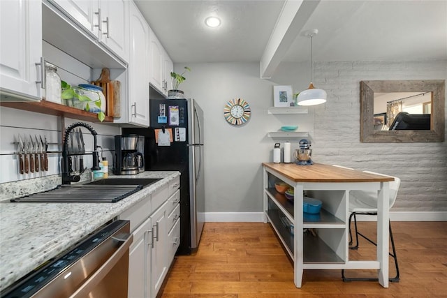 4 Sequoia Ct, Steamboat Springs, CO 80487 - kitchen with open shelves, white cabinets, dishwasher, light wood-type flooring, and pendant lighting