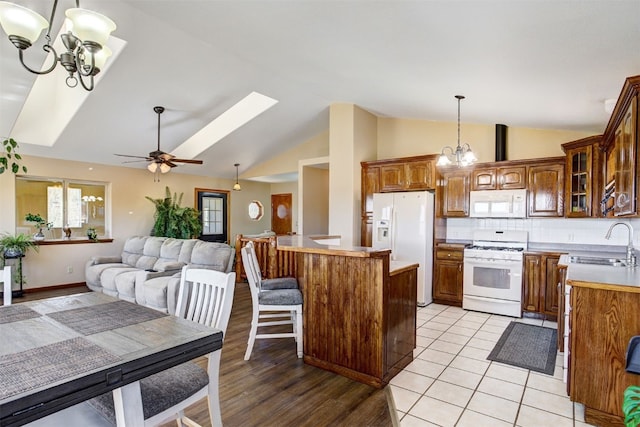 526 Sharps Way, Como, CO 80456 - kitchen featuring white appliances, a chandelier, a sink, vaulted ceiling, and glass insert cabinets