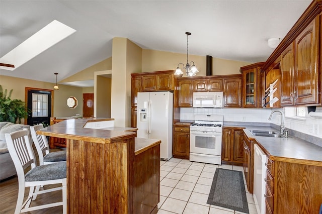 526 Sharps Way, Como, CO 80456 - kitchen featuring white appliances, lofted ceiling, a sink, a skylight, and a kitchen breakfast bar