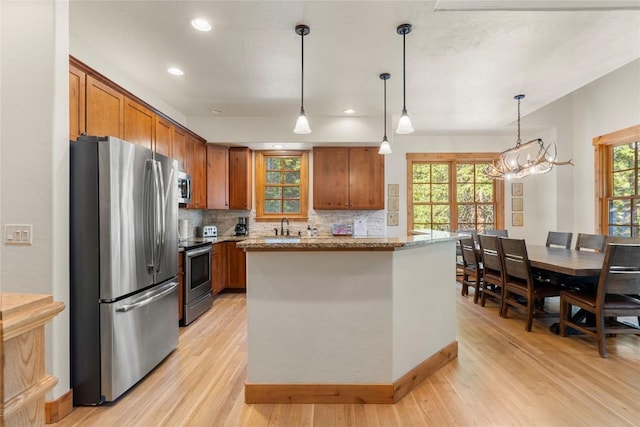 50 Cooney Ct, Blue River, CO 80424 - kitchen with appliances with stainless steel finishes, light wood-style floors, brown cabinetry, and recessed lighting