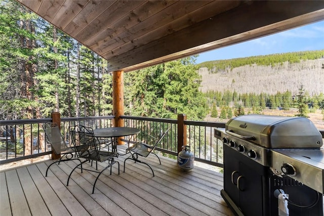 50 Cooney Ct, Blue River, CO 80424 - wooden terrace featuring a forest view, outdoor dining area, and grilling area