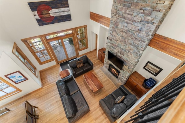 50 Cooney Ct, Blue River, CO 80424 - living room with a high ceiling, wood finished floors, and a stone fireplace