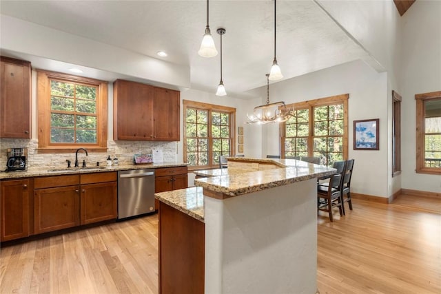 50 Cooney Ct, Blue River, CO 80424 - kitchen with dishwasher, light wood-type flooring, brown cabinets, tasteful backsplash, and recessed lighting