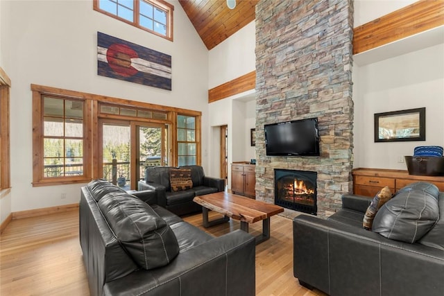 50 Cooney Ct, Blue River, CO 80424 - living area with high vaulted ceiling, light wood-type flooring, a stone fireplace, and wood ceiling