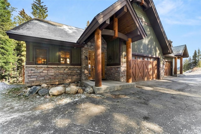 50 Cooney Ct, Blue River, CO 80424 - view of front facade featuring stone siding, an attached garage, and driveway