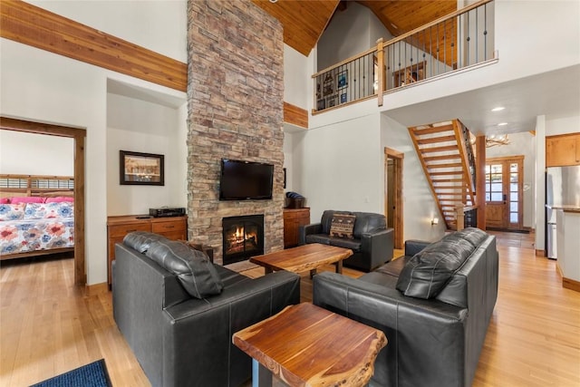 50 Cooney Ct, Blue River, CO 80424 - living room with light wood-style flooring, high vaulted ceiling, a fireplace, stairway, and wood ceiling