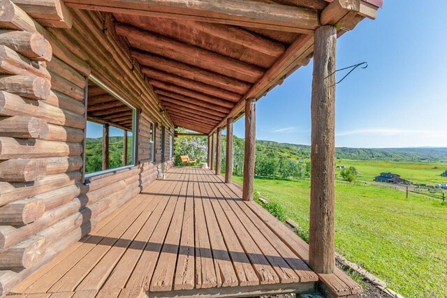 30955 Whitecotton Ct, Steamboat Springs, CO 80487 - wooden deck with a lawn and a view of rural / pastoral area
