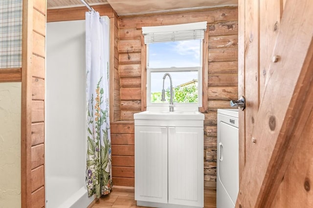 30955 Whitecotton Ct, Steamboat Springs, CO 80487 - full bath with a shower with shower curtain, vanity, and independent washer and dryer