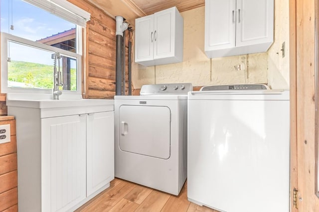 30955 Whitecotton Ct, Steamboat Springs, CO 80487 - laundry area with cabinet space, separate washer and dryer, and light wood-style flooring