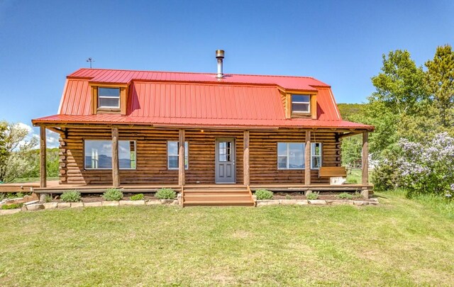 30955 Whitecotton Ct, Steamboat Springs, CO 80487 - view of front of home featuring log siding, metal roof, and a front lawn