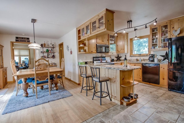 277 G Rd, Silverthorne, CO 80498 - kitchen with black appliances, open shelves, light stone counters, and pendant lighting