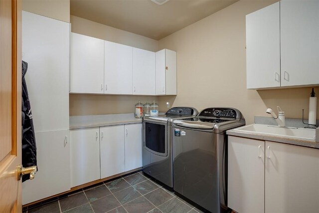 1064 Steamboat Blvd, Steamboat Springs, CO 80487 - laundry area with washing machine and dryer, dark tile patterned floors, a sink, and cabinet space