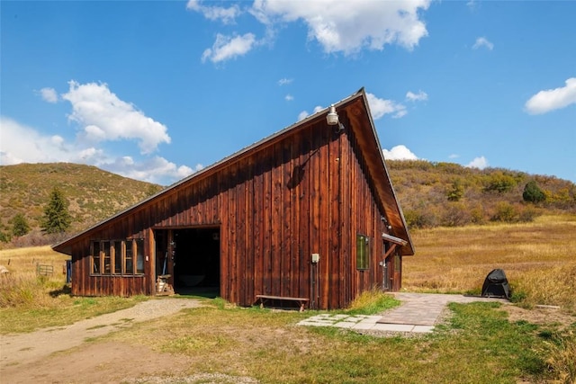 view of horse barn with a mountain view