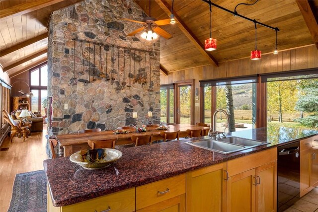 kitchen with ceiling fan, sink, wooden ceiling, beamed ceiling, and light wood-type flooring