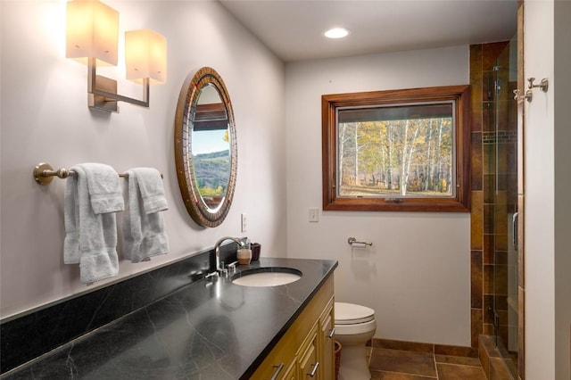 bathroom with tile patterned flooring, vanity, toilet, and a shower with door