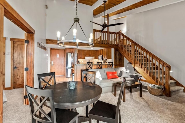 2275 Storm Meadows Dr Unit 63, Steamboat Springs, CO 80487 - dining space with a high ceiling, stairway, light colored carpet, a chandelier, and beamed ceiling