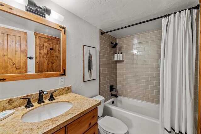 2275 Storm Meadows Dr Unit 63, Steamboat Springs, CO 80487 - full bathroom featuring vanity, toilet, shower / bathtub combination with curtain, and a textured ceiling