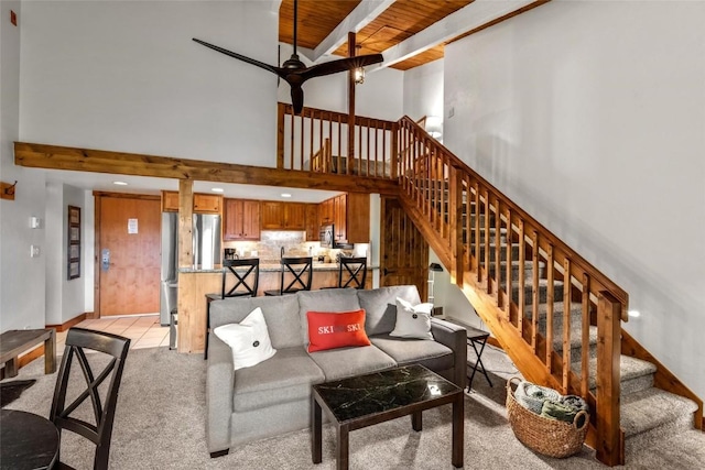 2275 Storm Meadows Dr Unit 63, Steamboat Springs, CO 80487 - living room with ceiling fan, light carpet, stairs, and a high ceiling