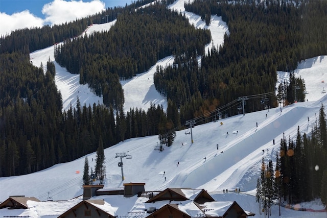 45 Beeler Pl Unit 301, Copper Mountain, CO 80443 - snowy aerial view with a view of trees and a mountain view