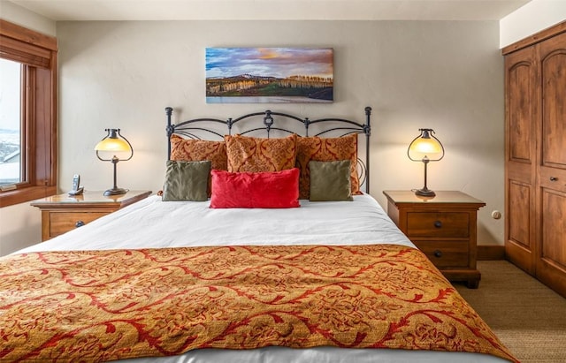 bedroom with a wall mounted air conditioner and carpet flooring