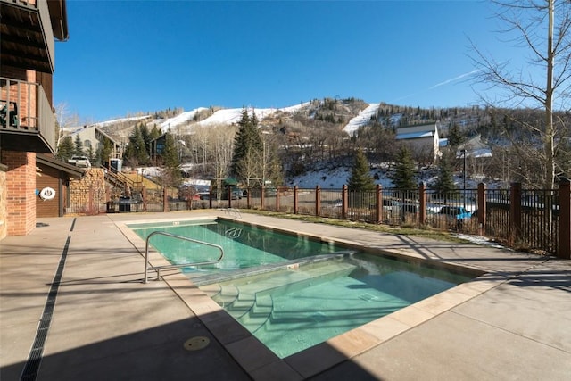 view of pool with a mountain view and a patio