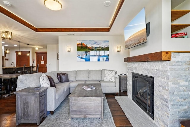 1521 Ski Hill Rd Unit 8312, Breckenridge, CO 80424 - living room with a raised ceiling, dark wood-style flooring, and a glass covered fireplace