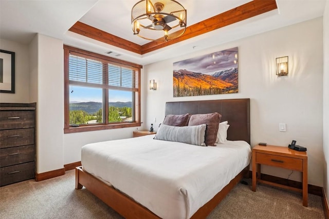 1521 Ski Hill Rd Unit 8312, Breckenridge, CO 80424 - carpeted bedroom featuring a raised ceiling and a chandelier