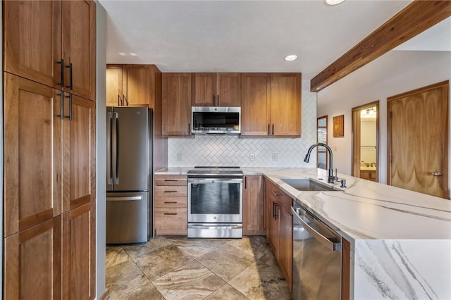 91200 Ryan Gulch Rd Unit 91222, Silverthorne, CO 80498 - kitchen with appliances with stainless steel finishes, a sink, brown cabinets, decorative backsplash, and beamed ceiling