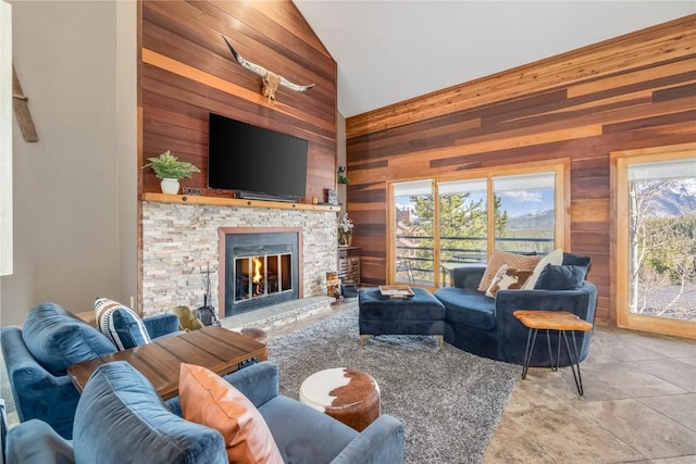 91200 Ryan Gulch Rd Unit 91222, Silverthorne, CO 80498 - living area with wooden walls, a fireplace, tile patterned floors, and high vaulted ceiling