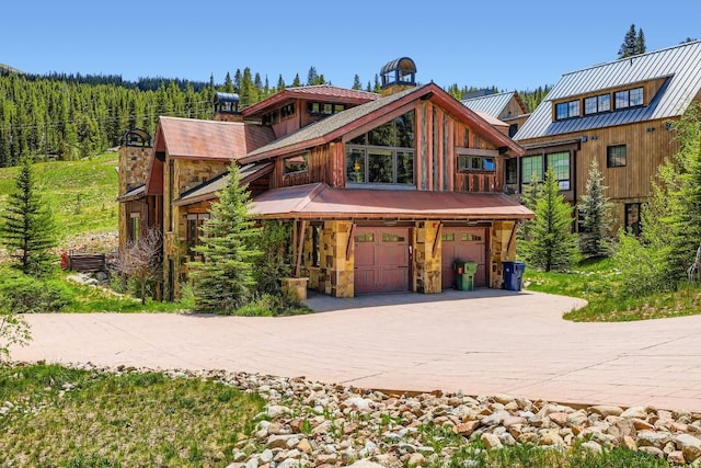 560 Beeler Pl, Frisco, CO 80443 - rustic home featuring a garage, driveway, and stone siding
