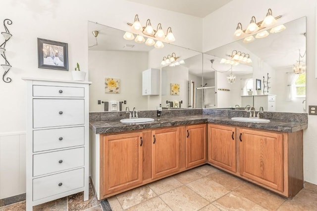 26870 Beaver Canyon Dr, Clark, CO 80428 - bathroom with double vanity, a shower with shower door, and stone tile flooring