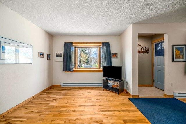 3 Cypress Ct Unit 3, Steamboat Springs, CO 80487 - sitting room featuring baseboards, a textured ceiling, baseboard heating, and light wood-style floors