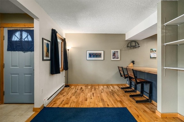 3 Cypress Ct Unit 3, Steamboat Springs, CO 80487 - interior space with baseboards, a textured ceiling, a baseboard heating unit, and wood finished floors
