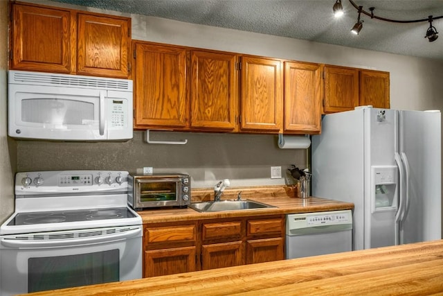 3 Cypress Ct Unit 3, Steamboat Springs, CO 80487 - kitchen featuring a sink, a toaster, brown cabinets, and white appliances
