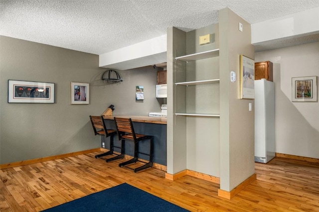 3 Cypress Ct Unit 3, Steamboat Springs, CO 80487 - bar with baseboards, a textured ceiling, wood finished floors, and white microwave