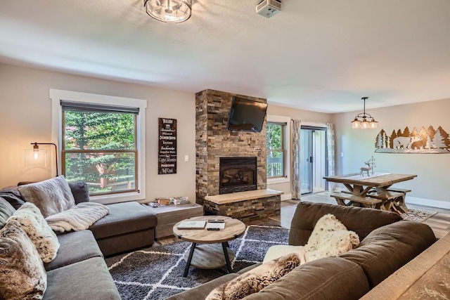 815 Columbine Rd Unit 22, Breckenridge, CO 80424 - living area featuring plenty of natural light, wood finished floors, and a stone fireplace
