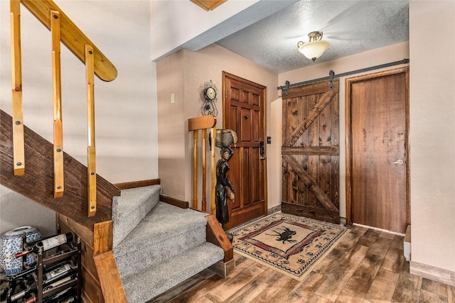 1149 Overlook Dr Unit C3, Steamboat Springs, CO 80487 - foyer with baseboards, wood finished floors, stairs, and a textured ceiling