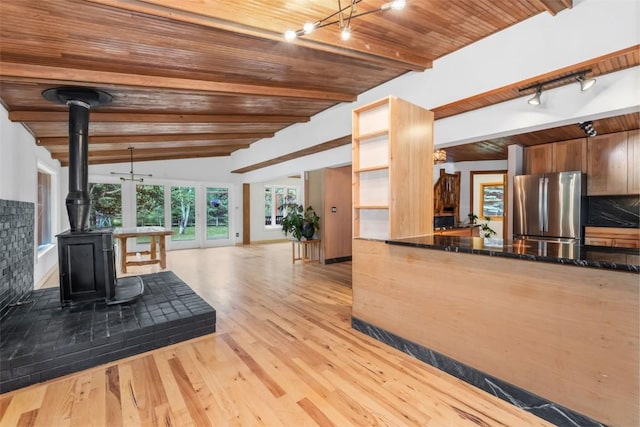 50035 Moon Hill Dr, Steamboat Springs, CO 80487 - kitchen with freestanding refrigerator, a wood stove, wood finished floors, open floor plan, and wood ceiling
