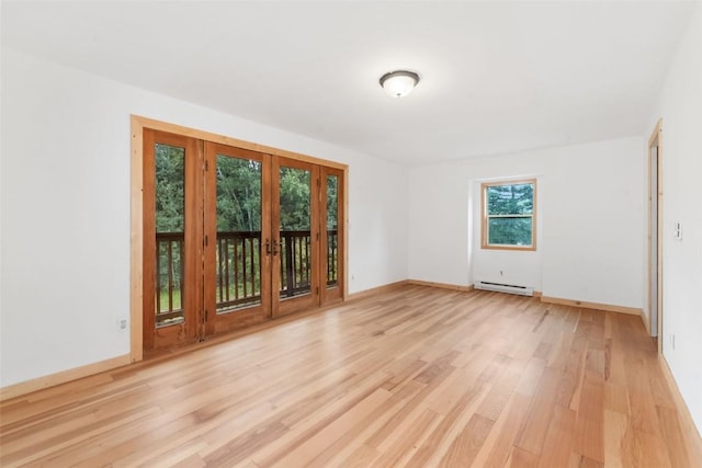 50035 Moon Hill Dr, Steamboat Springs, CO 80487 - empty room with a baseboard heating unit, light wood finished floors, and french doors