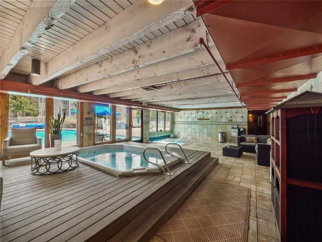 indoor community pool with an in-ground hot tub