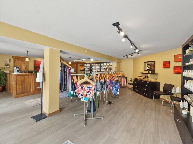 miscellaneous room featuring light wood finished floors and track lighting