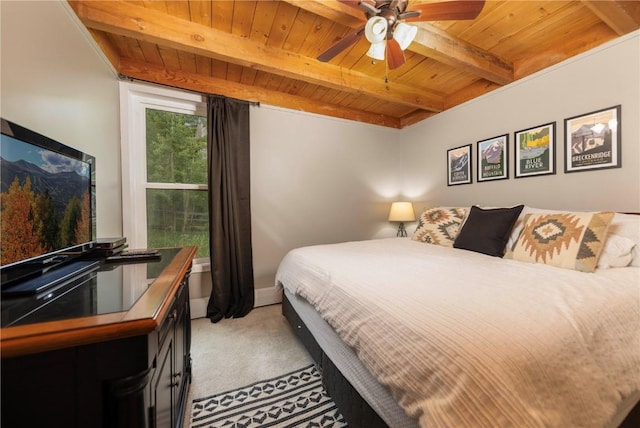 bedroom featuring beamed ceiling, ceiling fan, wooden ceiling, and light colored carpet